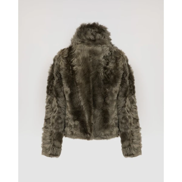Woman wearing Yves Salomon shearling fur coat – luxury outerwear at Coveti