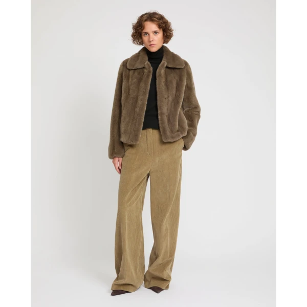 Woman wearing Yves Salomon shearling fur coat – luxury outerwear at Coveti