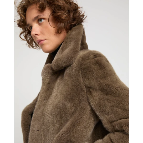 Woman wearing Yves Salomon shearling fur coat – luxury outerwear at Coveti