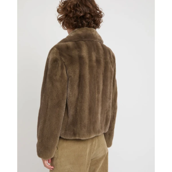 Woman wearing Yves Salomon shearling fur coat – luxury outerwear at Coveti