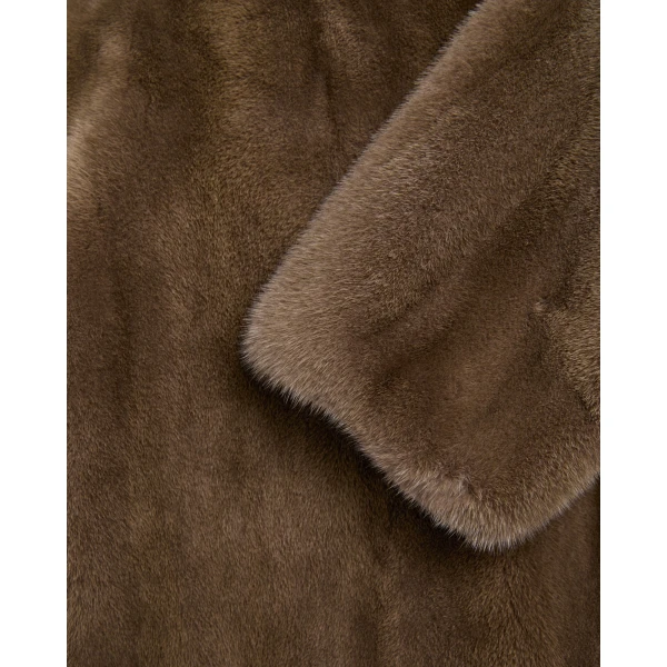 Woman wearing Yves Salomon shearling fur coat – luxury outerwear at Coveti