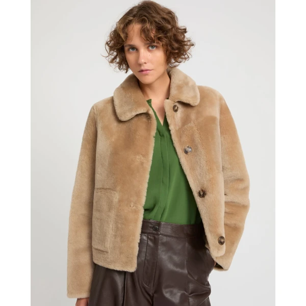 Woman wearing Yves Salomon shearling fur coat – luxury outerwear at Coveti