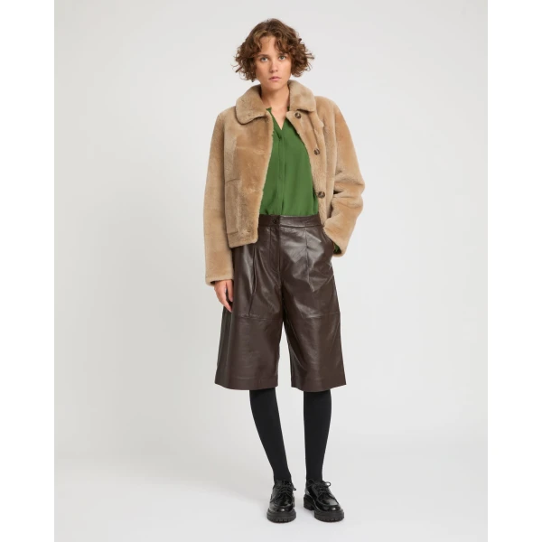 Woman wearing Yves Salomon shearling fur coat – luxury outerwear at Coveti
