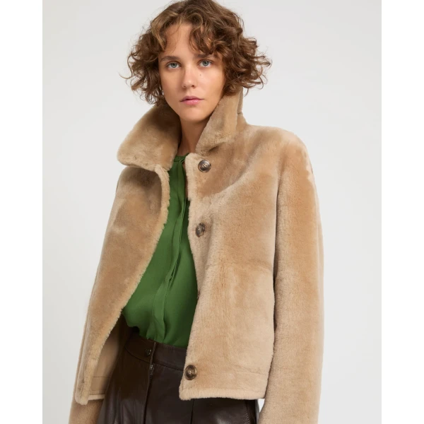 Woman wearing Yves Salomon shearling fur coat – luxury outerwear at Coveti
