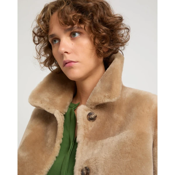 Woman wearing Yves Salomon shearling fur coat – luxury outerwear at Coveti
