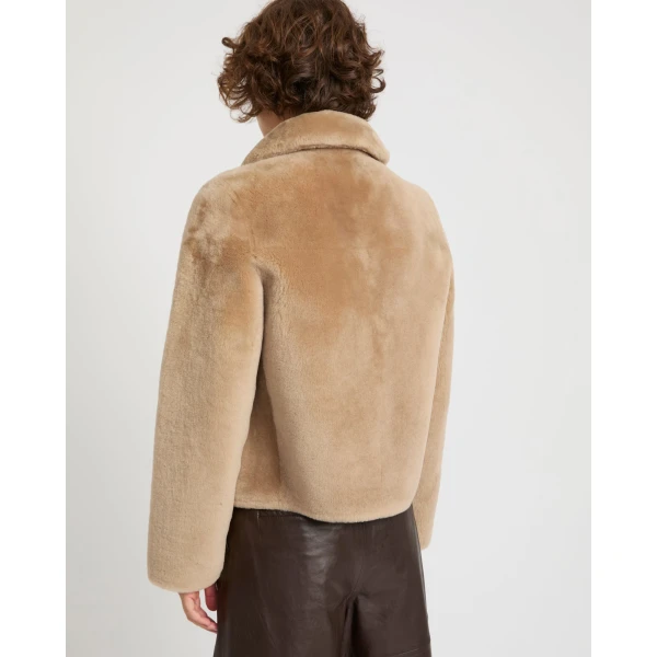 Woman wearing Yves Salomon shearling fur coat – luxury outerwear at Coveti