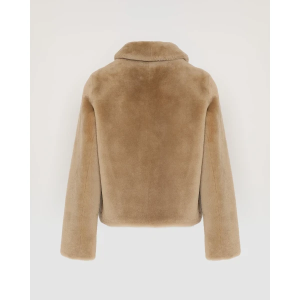 Woman wearing Yves Salomon shearling fur coat – luxury outerwear at Coveti