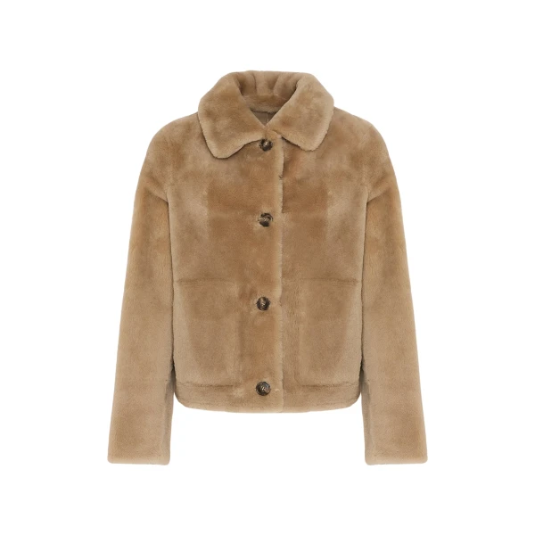 Woman wearing Yves Salomon shearling fur coat – luxury outerwear at Coveti