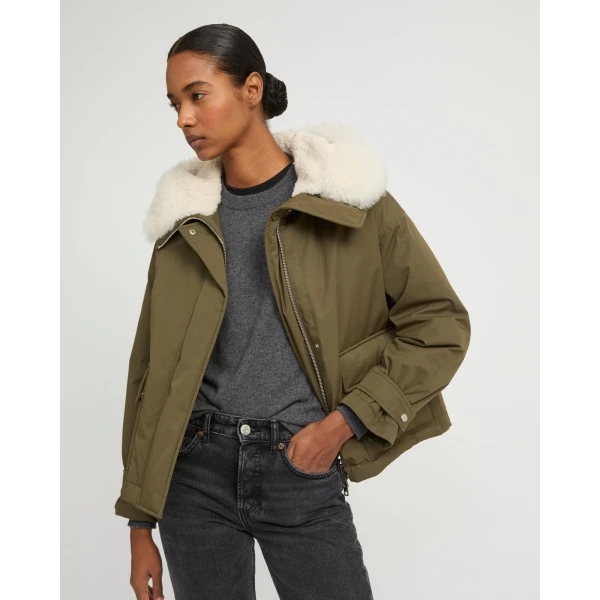 Woman wearing Yves Salomon shearling fur coat – luxury outerwear at Coveti