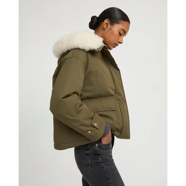 Woman wearing Yves Salomon shearling fur coat – luxury outerwear at Coveti