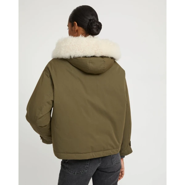 Woman wearing Yves Salomon shearling fur coat – luxury outerwear at Coveti