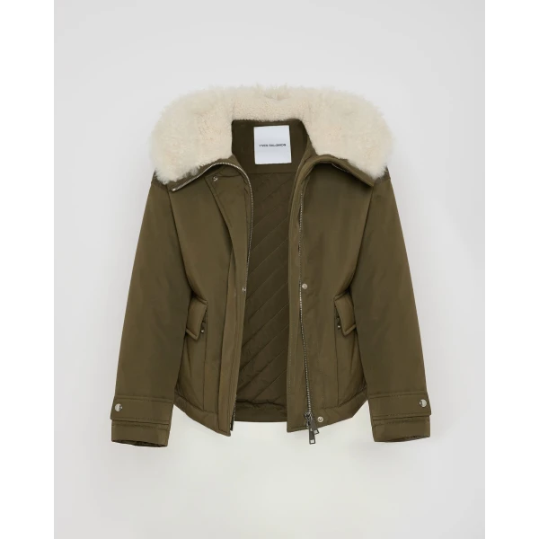 Woman wearing Yves Salomon shearling fur coat – luxury outerwear at Coveti