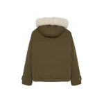 Woman wearing Yves Salomon shearling fur coat – luxury outerwear at Coveti