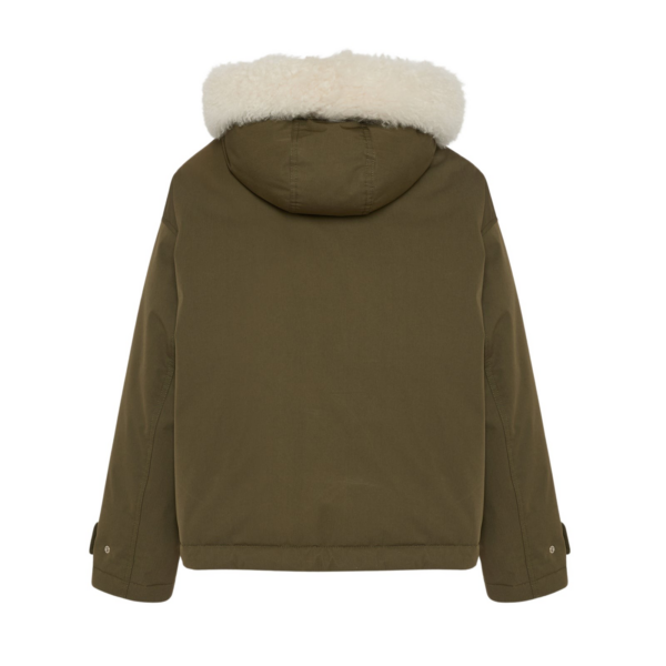 Woman wearing Yves Salomon shearling fur coat – luxury outerwear at Coveti