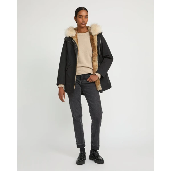Woman wearing Yves Salomon shearling fur coat – luxury outerwear at Coveti