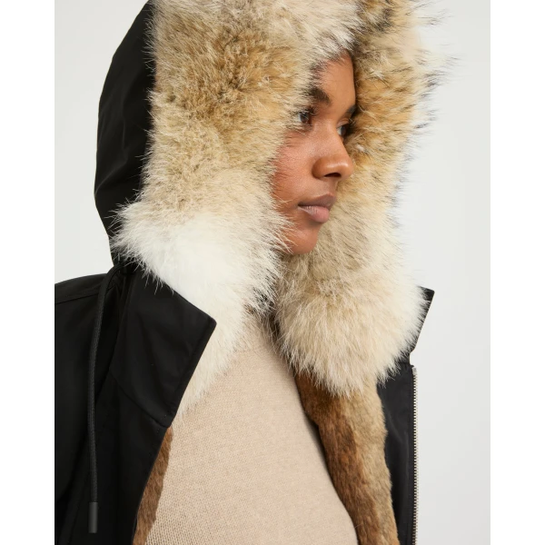 Woman wearing Yves Salomon shearling fur coat – luxury outerwear at Coveti