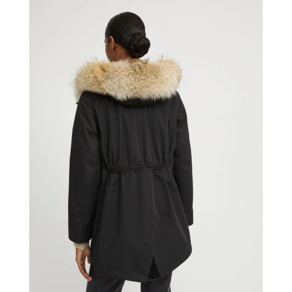 Woman wearing Yves Salomon shearling fur coat – luxury outerwear at Coveti