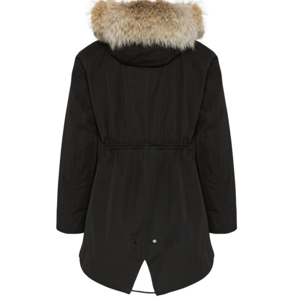 Woman wearing Yves Salomon shearling fur coat – luxury outerwear at Coveti