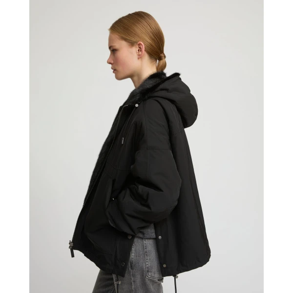 Woman wearing Yves Salomon shearling fur coat – luxury outerwear at Coveti