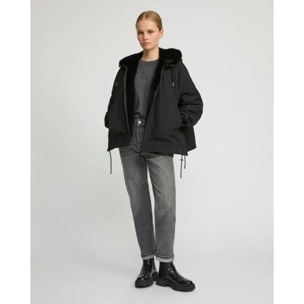 Woman wearing Yves Salomon shearling fur coat – luxury outerwear at Coveti