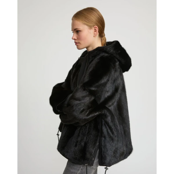 Woman wearing Yves Salomon shearling fur coat – luxury outerwear at Coveti
