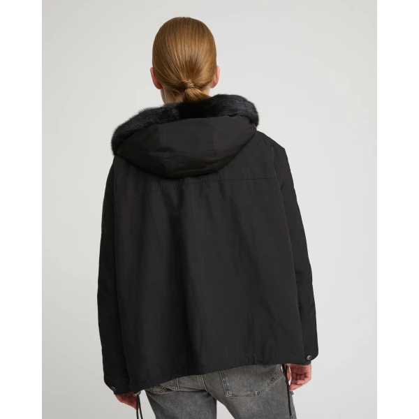 Woman wearing Yves Salomon shearling fur coat – luxury outerwear at Coveti