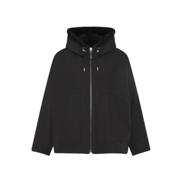Woman wearing Yves Salomon shearling fur coat – luxury outerwear at Coveti
