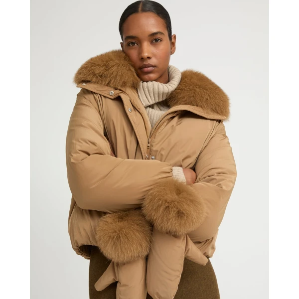 Woman wearing Yves Salomon shearling fur coat – luxury outerwear at Coveti
