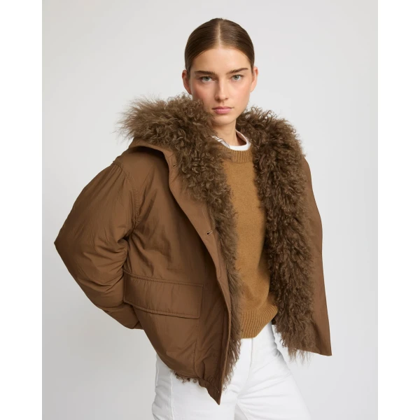 Woman wearing Yves Salomon shearling fur coat – luxury outerwear at Coveti