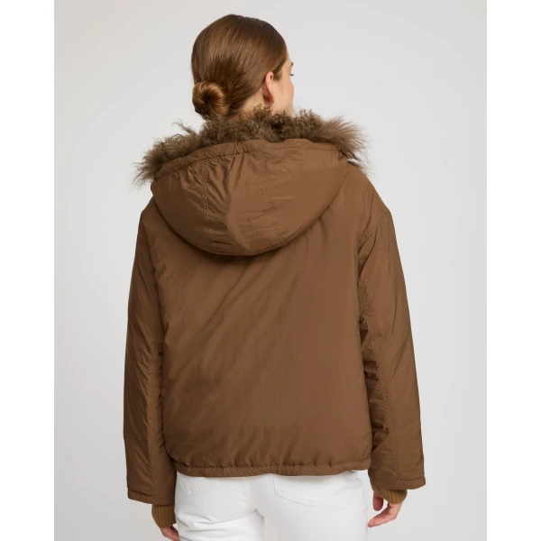 Woman wearing Yves Salomon shearling fur coat – luxury outerwear at Coveti