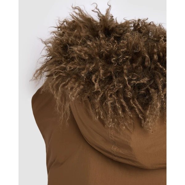 Woman wearing Yves Salomon shearling fur coat – luxury outerwear at Coveti