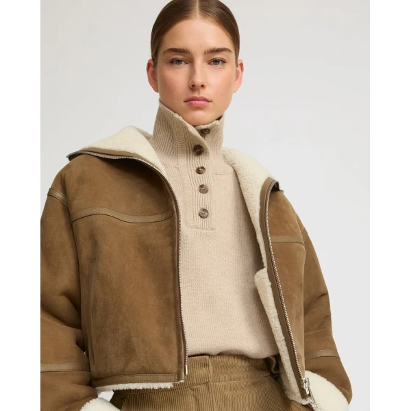 Woman wearing Yves Salomon shearling fur coat – luxury outerwear at Coveti