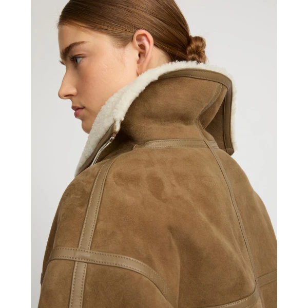 Woman wearing Yves Salomon shearling fur coat – luxury outerwear at Coveti