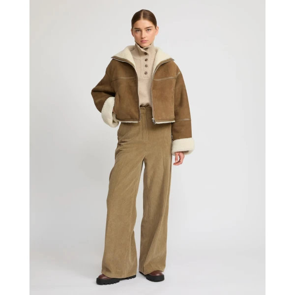 Woman wearing Yves Salomon shearling fur coat – luxury outerwear at Coveti