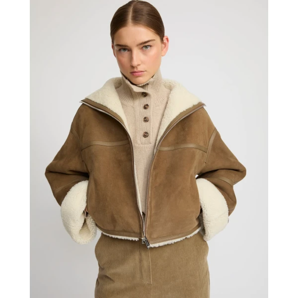 Woman wearing Yves Salomon shearling fur coat – luxury outerwear at Coveti