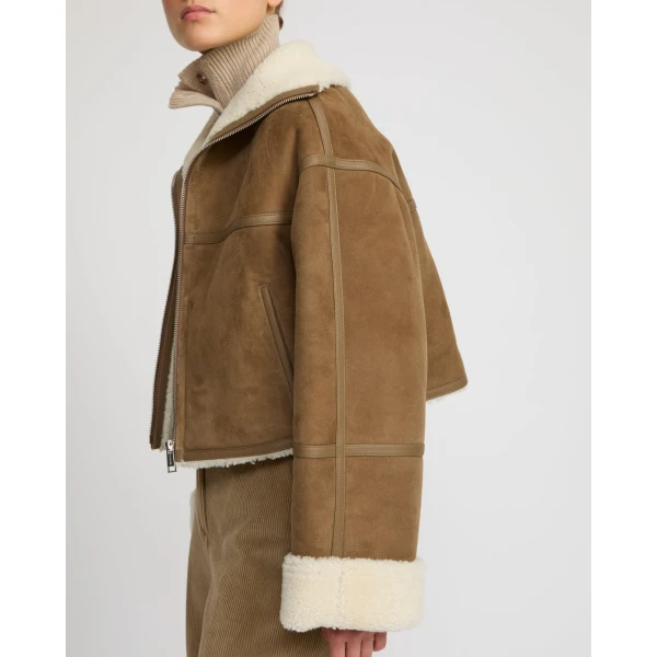 Woman wearing Yves Salomon shearling fur coat – luxury outerwear at Coveti