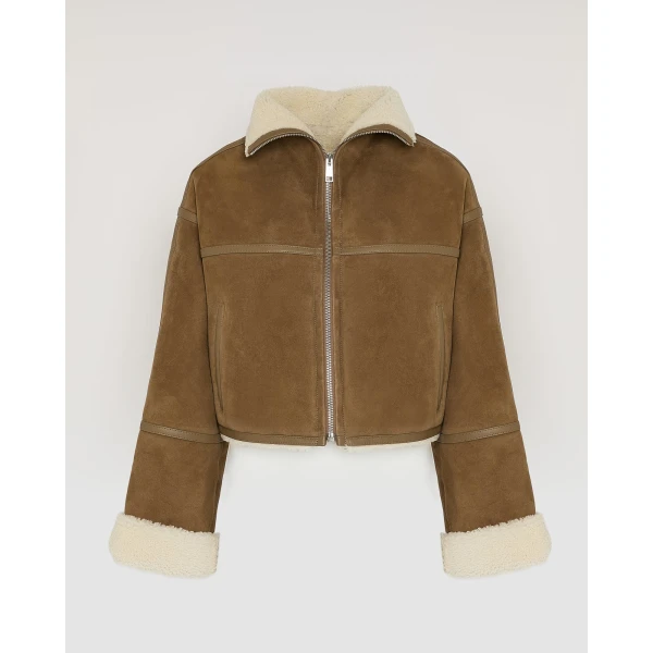 Woman wearing Yves Salomon shearling fur coat – luxury outerwear at Coveti