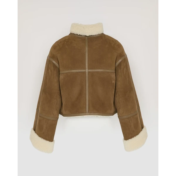 Woman wearing Yves Salomon shearling fur coat – luxury outerwear at Coveti