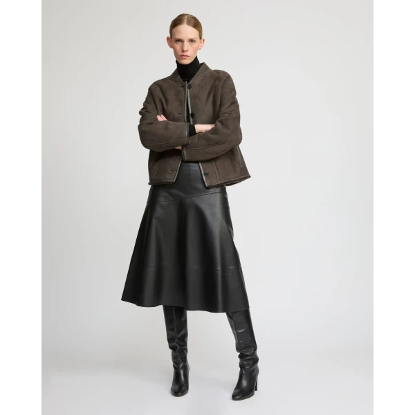 Woman wearing Yves Salomon shearling fur coat – luxury outerwear at Coveti