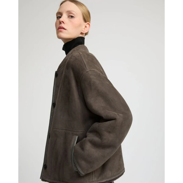 Woman wearing Yves Salomon shearling fur coat – luxury outerwear at Coveti