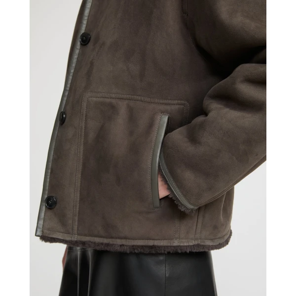Woman wearing Yves Salomon shearling fur coat – luxury outerwear at Coveti