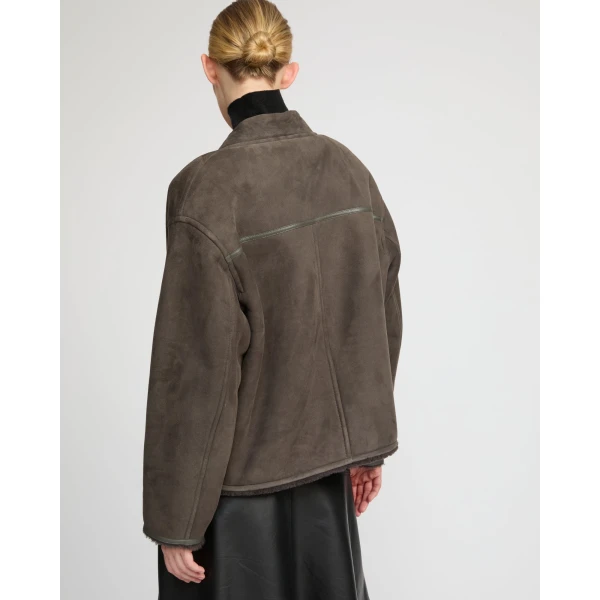 Woman wearing Yves Salomon shearling fur coat – luxury outerwear at Coveti
