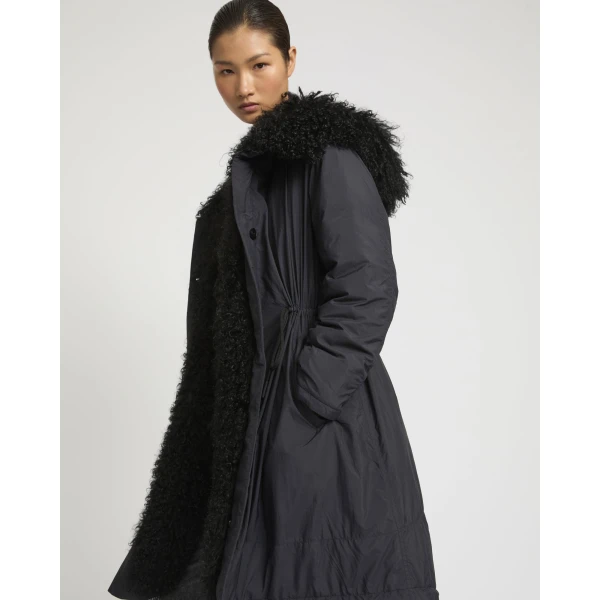 Woman wearing Yves Salomon shearling fur coat – luxury outerwear at Coveti