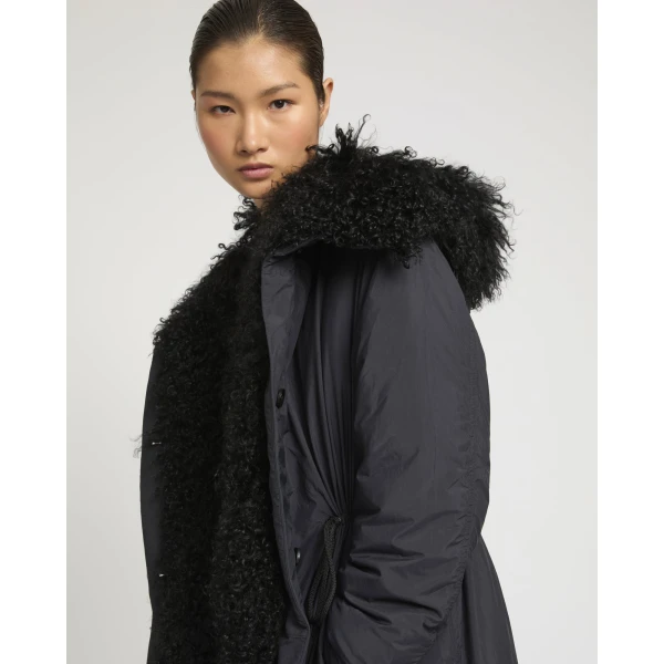 Woman wearing Yves Salomon shearling fur coat – luxury outerwear at Coveti