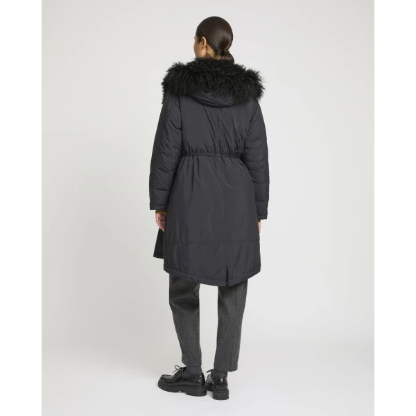 Woman wearing Yves Salomon shearling fur coat – luxury outerwear at Coveti
