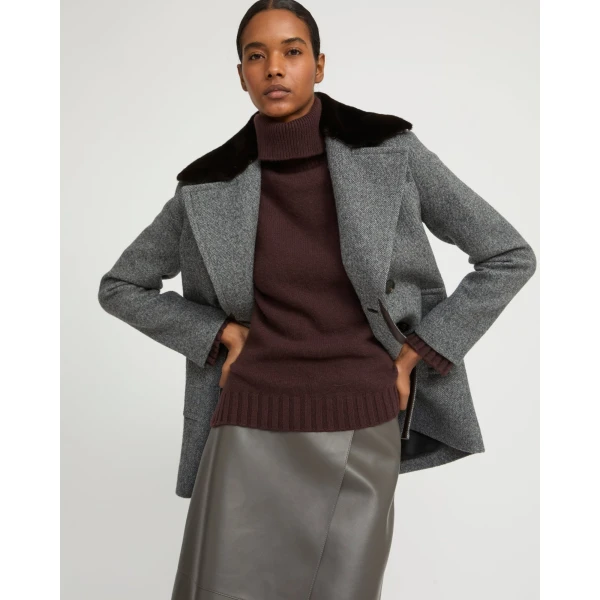 Woman wearing Yves Salomon shearling fur coat – luxury outerwear at Coveti