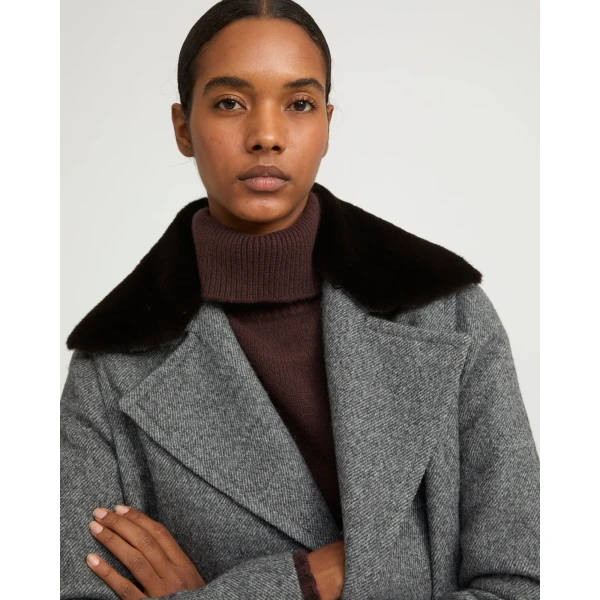 Woman wearing Yves Salomon shearling fur coat – luxury outerwear at Coveti