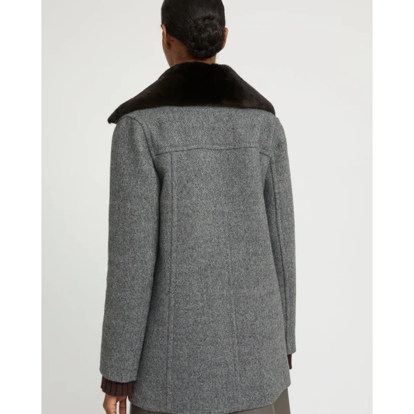 Woman wearing Yves Salomon shearling fur coat – luxury outerwear at Coveti