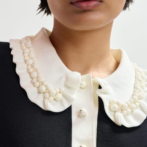 Essentiel Antwerp Black and off-white ruffle fine-knit polo top with bead embellishments - Essentiel Antwerp Tops - Colorful Belgian Design - Shop at Coveti