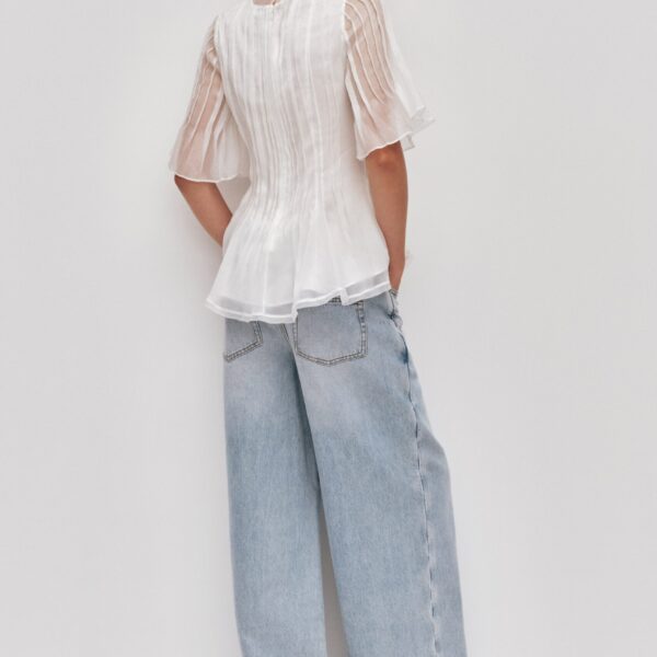 Aje Aus Tops – structured silhouette with raw femininity from Coveti